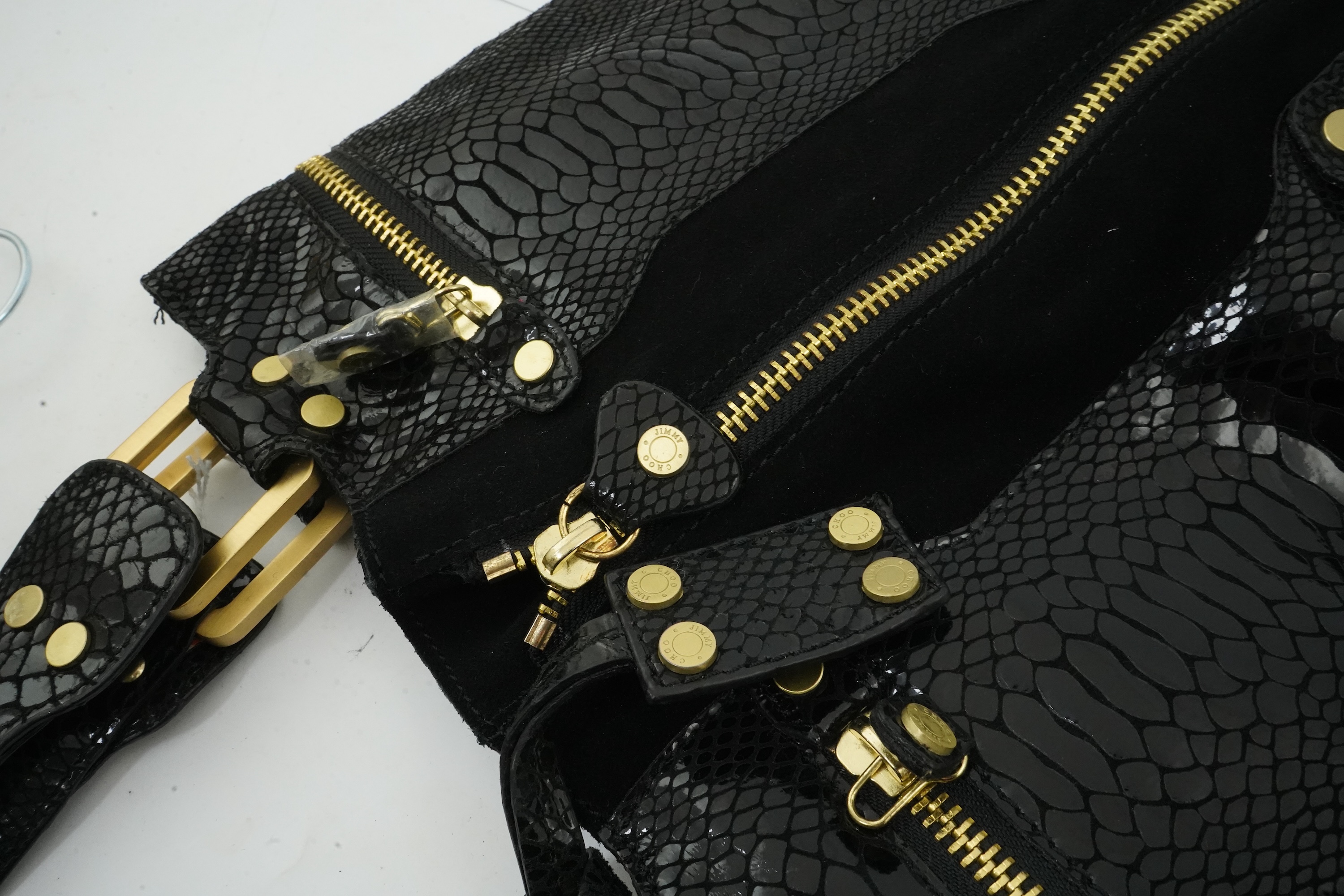 A vintage Jimmy Choo black snakeskin and elasticated material handbag with zip detail.